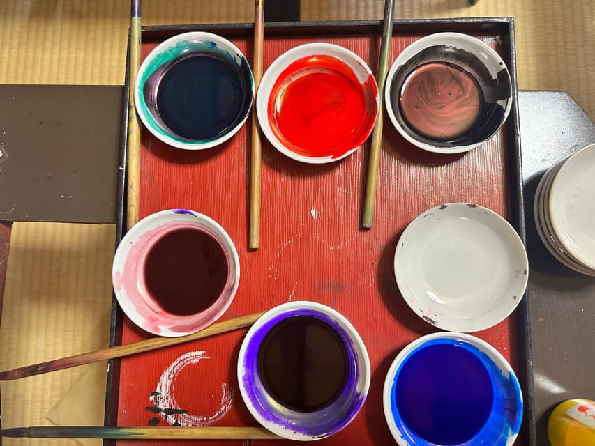 Kyoto: Traditional Yuzen Dyeing Experience - Painting silk while the interpreter explains the craft