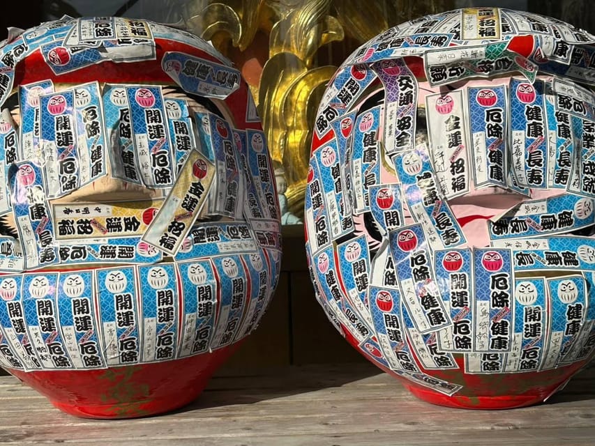Naha: Guided E-Bike Tour of the 12 Zodiac Temples - Daruma Temple and bright red prayer figures