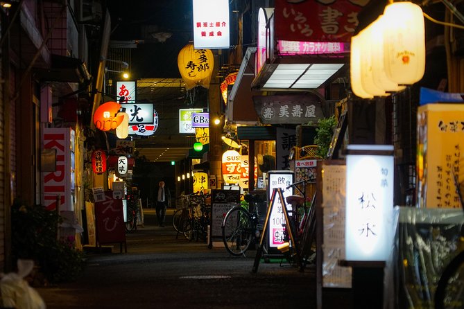 Osaka Bar Hopping Night Walking Tour in Namba (3 bars, 6 tastes) - Walking past the Glico sign and Shinsaibashi