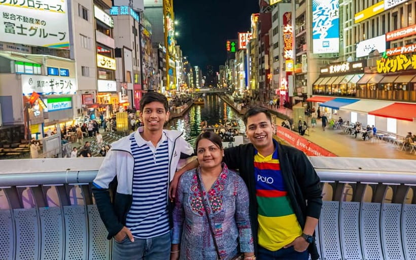 Osaka: Private Vibrant Nighttime Photoshoot (Dotonbori) - Getting the Glico Sign photograph