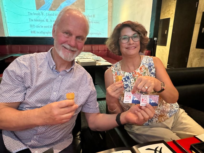 Tokyo: Calligraphy on Kanji Fan & Scroll with Drink - The hanko stamp and the generous souvenir bag